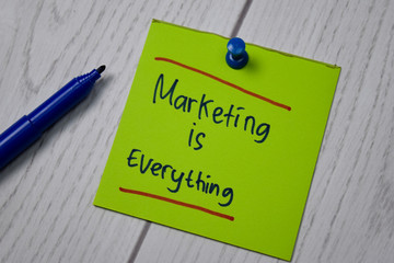 Marketing Is Everything write on a book isolated on wooden table.