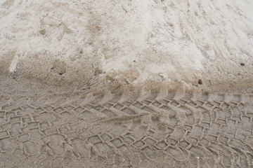 Tire tracks in the wet sand. Texture, background.