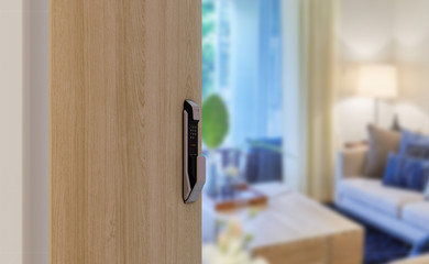 Digital door lock installed on wood door for security and access the room. Door wood texture with electronic door lock opened in front of blur living room. Selective focus.