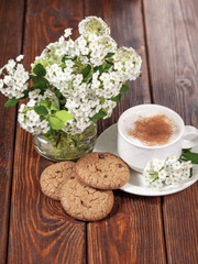 Breakfast with a cup of cappuccino with cinnamon and chocolate chip cookies