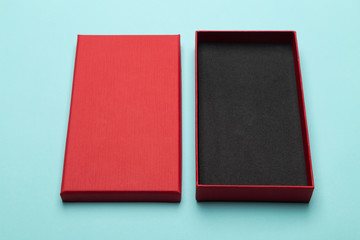 Fototapeta premium Red box product packaging isolated on blue background.
