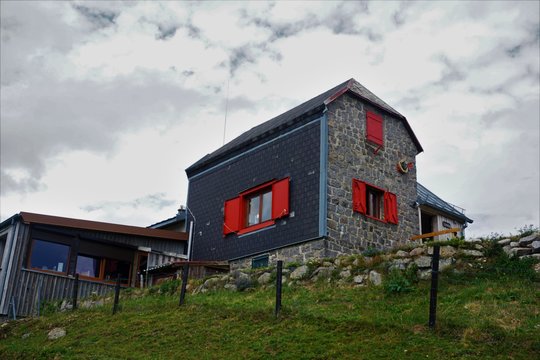 Beautiful mountain restaurant with red window frames spotted in the Vosges