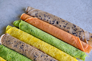 Pancakes of different color. Spinach, beetroot powder, blueberry and turmeric crepes.