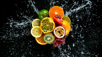 Fototapeta na wymiar Super Slow Motion Shot of Fresh Fruits with Splashing Water Isolated on Black Background.