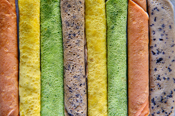 Pancakes of different color. Spinach, beetroot powder, blueberry and turmeric crepes.