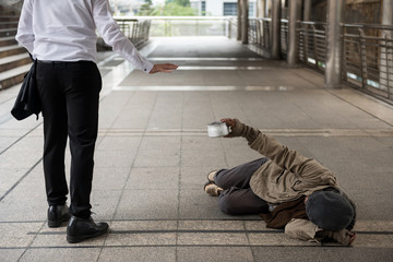 Businessman refuse homeless old man