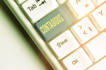 Writing note showing Contagious. Business concept for transmissible by direct or indirect contact...