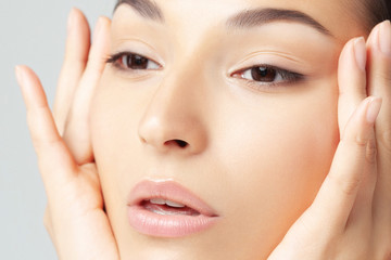Fototapeta premium Portrait of young beautiful woman with clean perfect skin