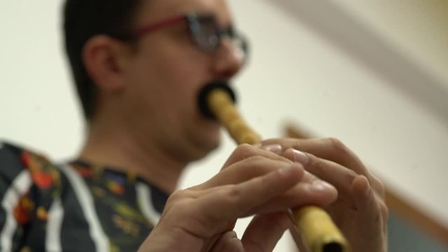 A musician blowing Ney, Close Up