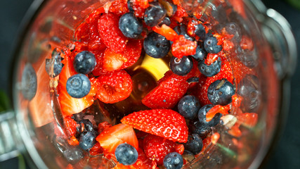 Berries fresh smoothie blended in blender, top view. Healthy eating concept.