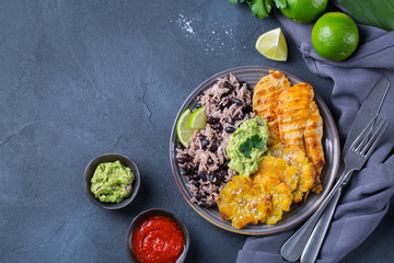Rice with black beans, fried chicken breast and tostones, plantains © aamulya
