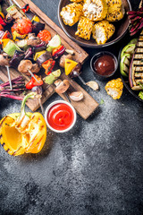 Assortment various barbecue vegan food, set of grill veggies, vegetable bbq party fest, grilled corn, vegan skewers kebabs, hot vegetable salad, with sauces & spices. Vegetarian seasonal summer food