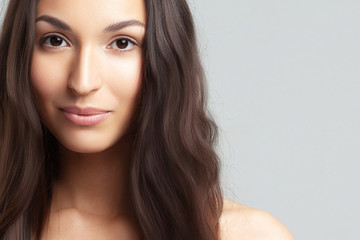 Naklejka premium Portrait of young beautiful woman with clean perfect skin
