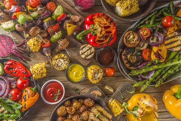 Assortment various barbecue vegan food, set of grill veggies, vegetable bbq party fest, grilled corn, vegan skewers kebabs, hot vegetable salad, with sauces & spices. Vegetarian seasonal summer food