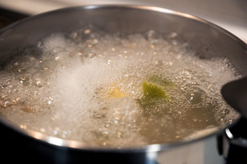 Saucepan with boiling water and pasta inside cooking