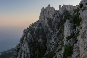 Silhouette of Mount Ai-Petri at sunset. Lone pines. Crimea.