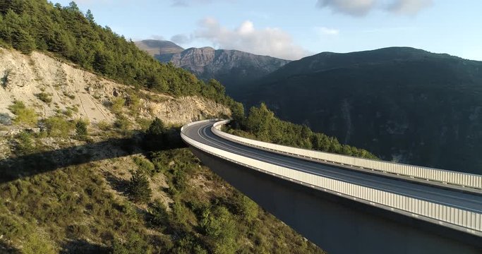 Stunning curved bridge in Pyrenees mountains at sunset