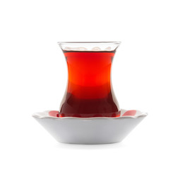 Turkish Tea in traditional glass with traditional tea plate. Turkish Tea glass with thin waist. Isolated white background. Clipping Path.