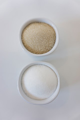 sugar cane and white sugar in sugar bowl
