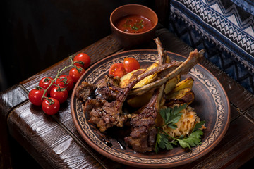 Hospitable Georgian cuisine. Grilled veal ribs with vegetables
