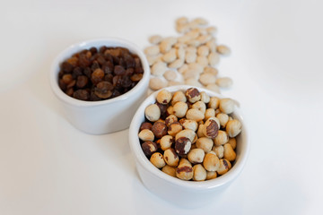 dry fruits isolated in white pots