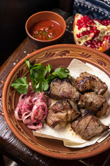 Grilled meat on pita with pickled onions and herbs