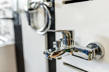 Water mixer tab in a bathroom interior shop.