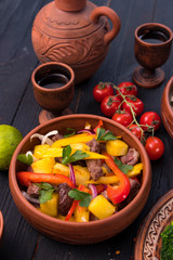 Hospitable Georgian cuisine. Warm salad with meat
