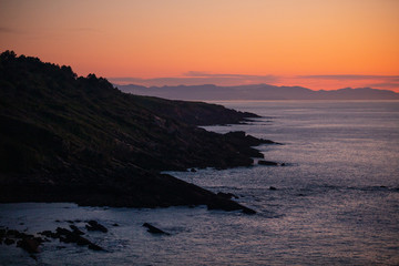 Fototapeta na wymiar Sunset in the basque coast under Jaizkibel mountain in Hondarribia, Basque Country.