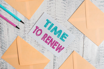 Writing note showing Time To Renew. Business concept for extending the period of time when something is valid Envelopes highlighters ruled paper sheet wooden vintage background