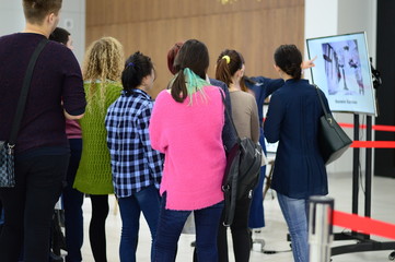 a group of people looking at the screen in the room