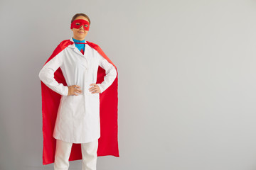 Doctor or nurse superhero on a gray background.