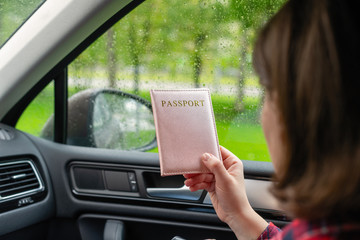 Passenger girl holding passport sitting in car for check customs officers. Border control concept....