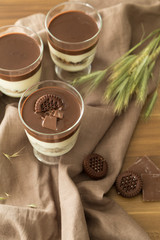 Service chocolate magnolia dessert with hazelnut on the wooden background.