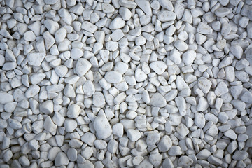 Small pebbles painted in white, texture.