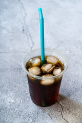 Take Away Cold Brew Coffee with Ice in Plastic Glass and Straw.