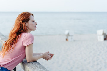 Fototapeta na wymiar Young redhead woman enjoying a day at the beach