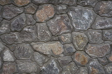Wall with imitation of natural stone, texture background.