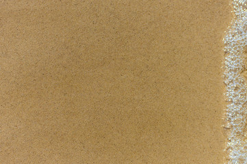 Sand background with water splashes, texture background close-up