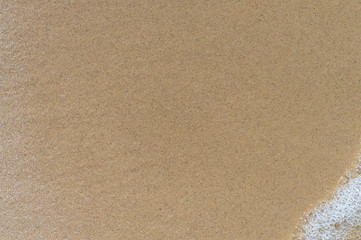 Fototapeta na wymiar Sand background with water splashes, texture background close-up