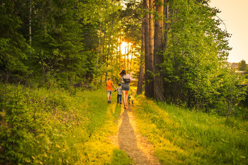 Mother and two children walking in the forest