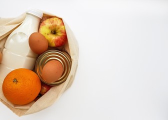 Food donations in a linen bag on a white background.