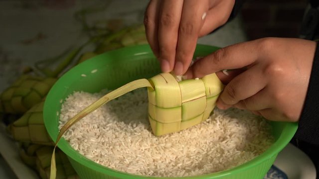 Ketupat (rice dumpling) is a local delicacy during the festive season in South East Asia, especially during eid fitri. It is a natural rice casing made from young coconut leaves, Selective Focus
