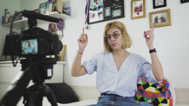 Young vloger making her video for blog. The girl turns on the camera and starts talking
