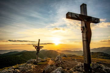 An Evocative Religious Cross on the Mountain Peak at the Sunrise Time with a Beautiful Sky - Jesus Resurrection - 