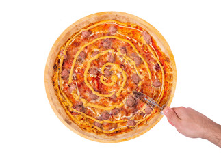 The man cuts the pizza with a pizza cutter, top view. Tasty pizza with beef sausages, mozzarella, various sauces and marinated red onions on a wooden platter, isolated on white background