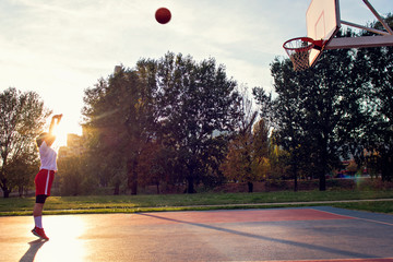woman basketball player have treining and exercise at basketball court at city on street