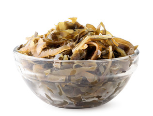 Seaweed in a plate close-up on a white. Isolated