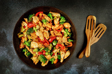 Stir fry vegetables with chicken and sauce on pan.