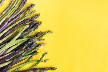 Vegetable border from fresh natural raw asparagus spears for cooking homemade diet food on a yellow...